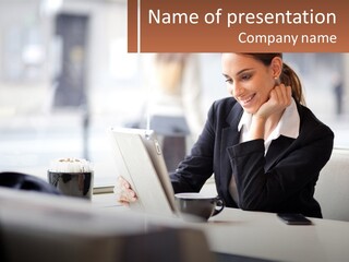 A Woman Sitting At A Table Using A Laptop Computer PowerPoint Template