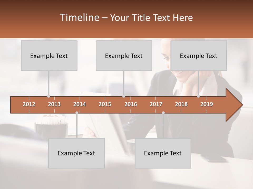 A Woman Sitting At A Table Using A Laptop Computer PowerPoint Template