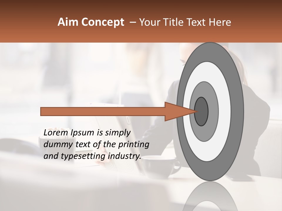 A Woman Sitting At A Table Using A Laptop Computer PowerPoint Template