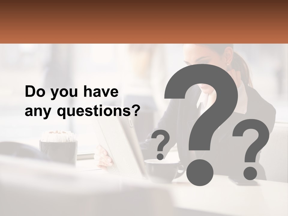 A Woman Sitting At A Table Using A Laptop Computer PowerPoint Template