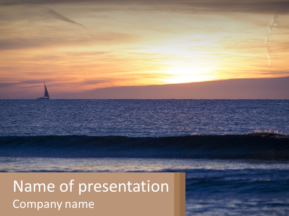 A Sailboat In The Ocean At Sunset PowerPoint Template