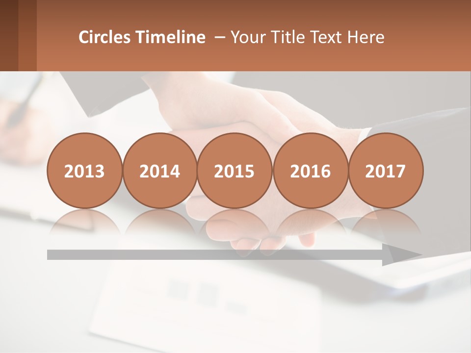 Two People Shaking Hands Over A Laptop Computer PowerPoint Template