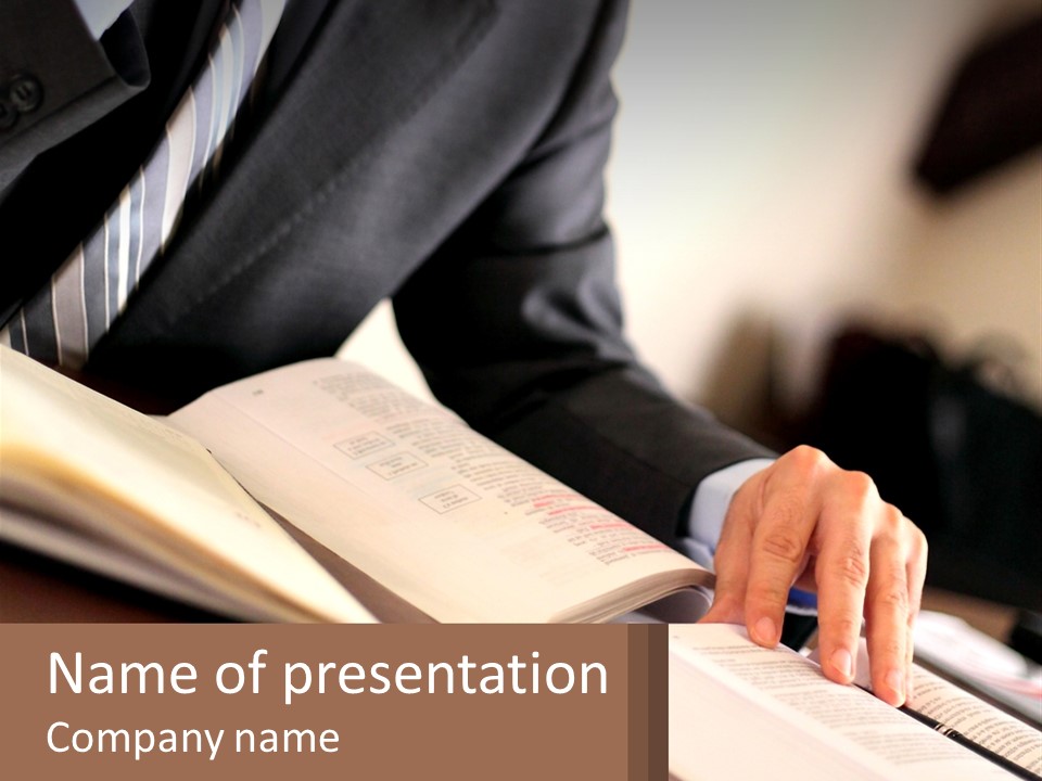 A Man In A Suit Is Typing On A Computer PowerPoint Template