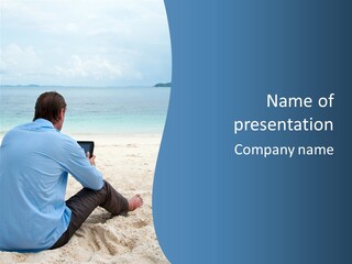 A Man Sitting On The Beach With A Laptop PowerPoint Template