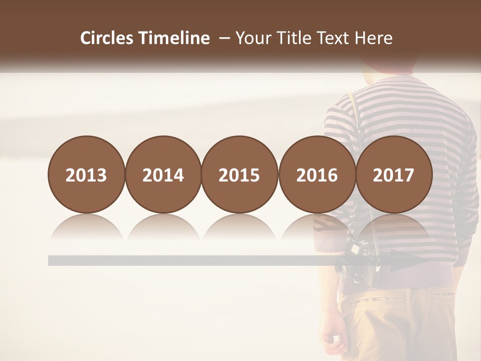 A Man Standing On A Beach With A Camera PowerPoint Template