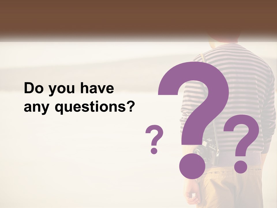 A Man Standing On A Beach With A Camera PowerPoint Template