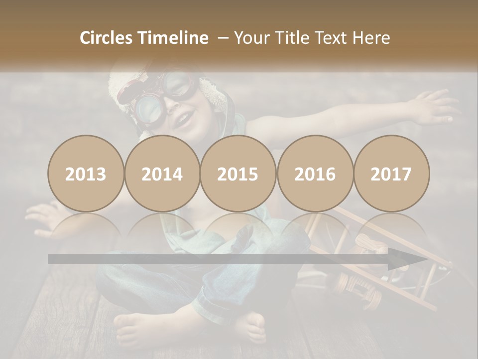 A Young Boy In A Hat And Scarf Sitting On A Wooden Floor PowerPoint Template