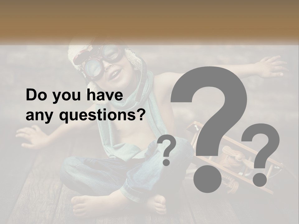 A Young Boy In A Hat And Scarf Sitting On A Wooden Floor PowerPoint Template