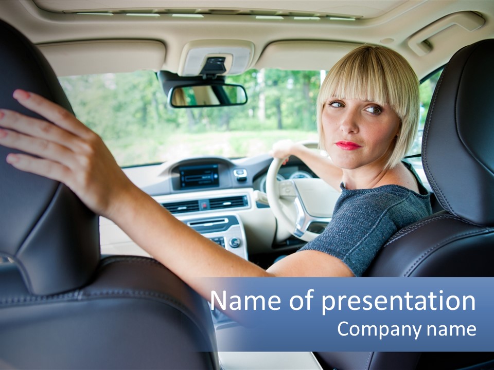 A Woman Driving A Car With Her Hand On The Steering Wheel PowerPoint Template