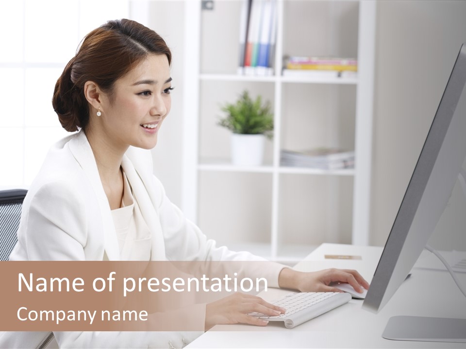 A Woman Sitting At A Desk Using A Computer PowerPoint Template