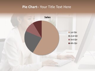 A Woman Sitting At A Desk Using A Computer PowerPoint Template