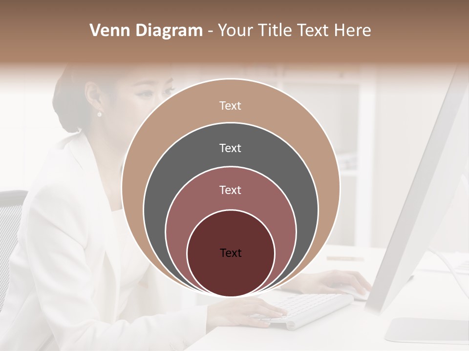 A Woman Sitting At A Desk Using A Computer PowerPoint Template