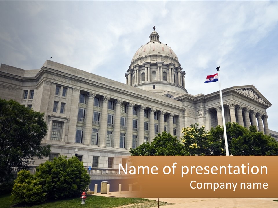 A Large Building With A Flag Flying In Front Of It PowerPoint Template