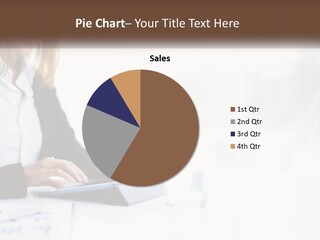 A Woman Sitting At A Table Using A Tablet Computer PowerPoint Template