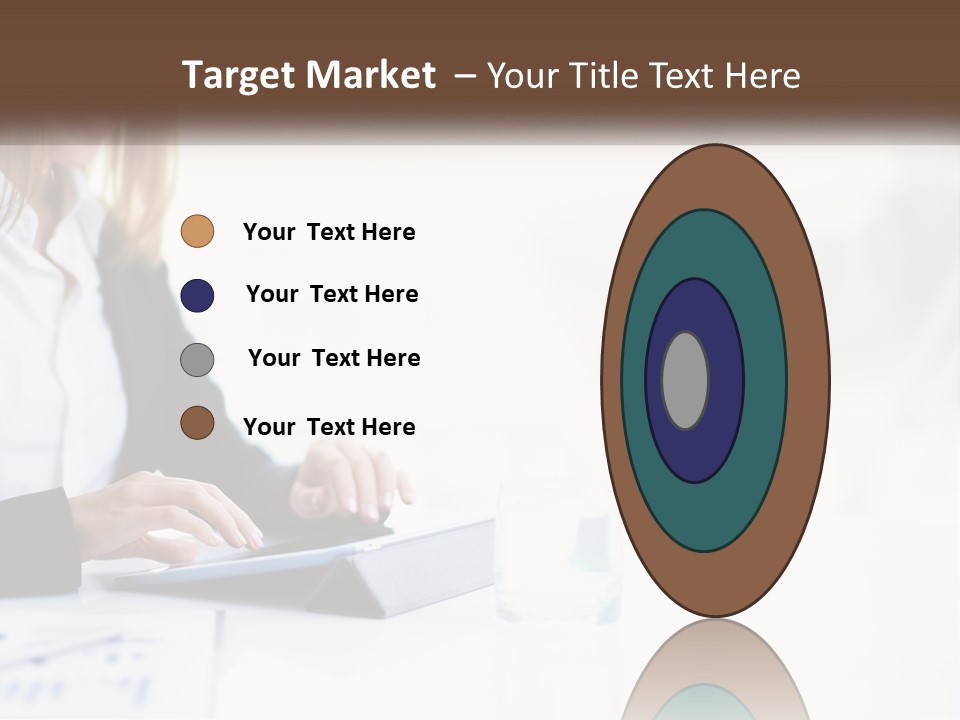 A Woman Sitting At A Table Using A Tablet Computer PowerPoint Template