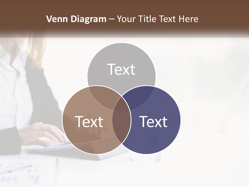 A Woman Sitting At A Table Using A Tablet Computer PowerPoint Template