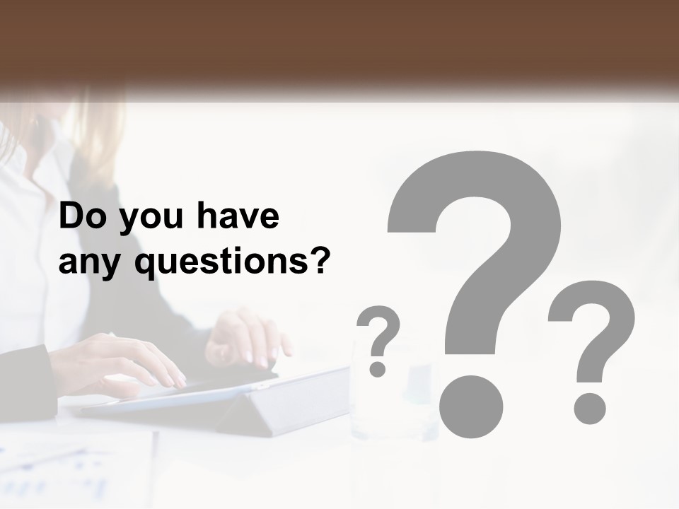 A Woman Sitting At A Table Using A Tablet Computer PowerPoint Template