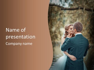 A Bride And Groom Are Hugging In Front Of A Tree PowerPoint Template