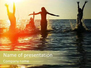 A Group Of People Splashing In The Water At Sunset PowerPoint Template
