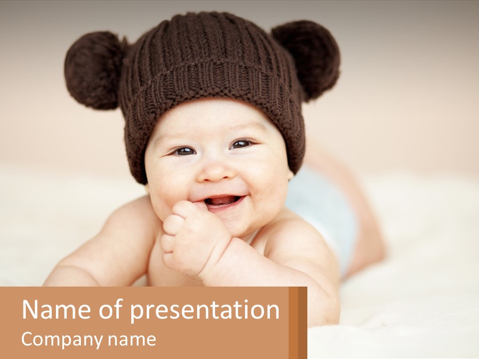 A Baby Wearing A Brown Hat Laying On Top Of A Bed PowerPoint Template