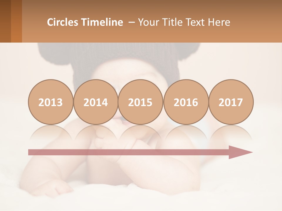 A Baby Wearing A Brown Hat Laying On Top Of A Bed PowerPoint Template