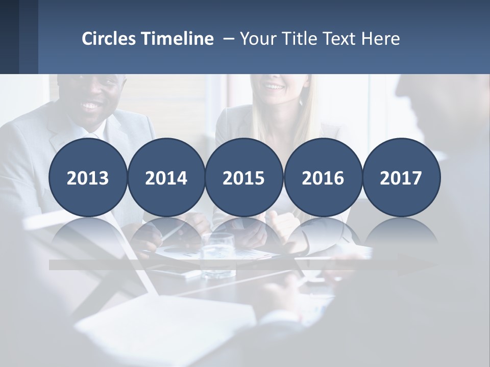 A Group Of People Sitting Around A Table PowerPoint Template