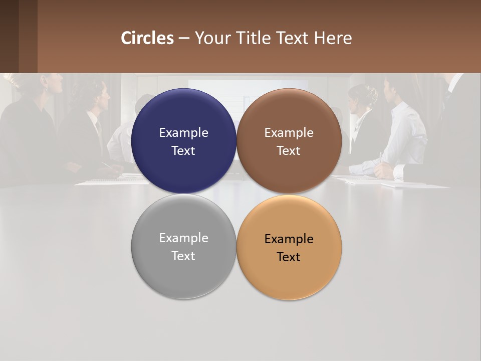 A Group Of People Sitting Around A Conference Table PowerPoint Template