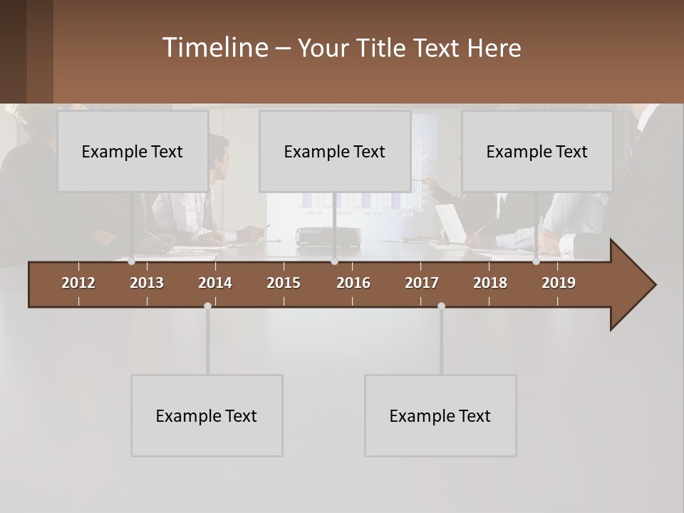 A Group Of People Sitting Around A Conference Table PowerPoint Template