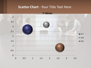 A Group Of People Sitting Around A Conference Table PowerPoint Template