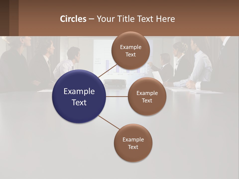A Group Of People Sitting Around A Conference Table PowerPoint Template