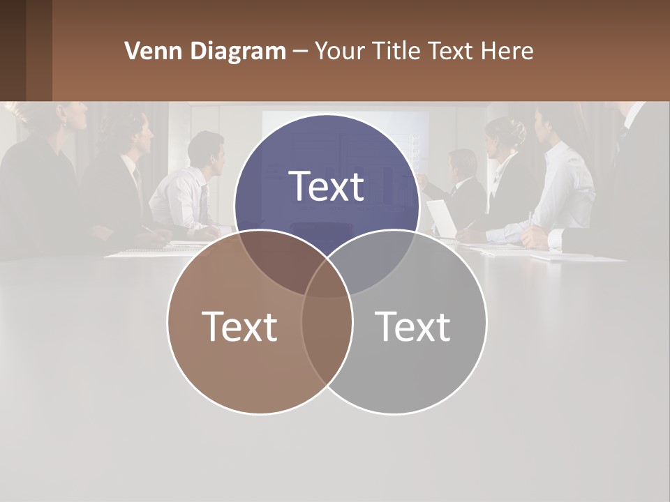 A Group Of People Sitting Around A Conference Table PowerPoint Template