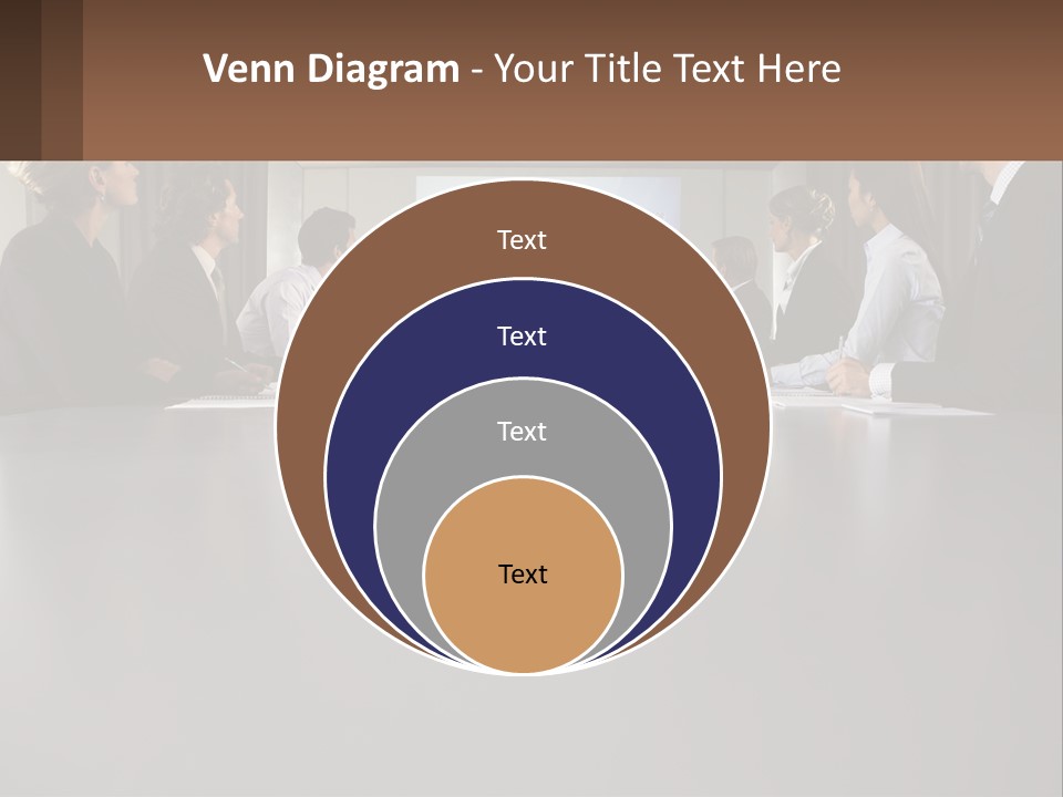 A Group Of People Sitting Around A Conference Table PowerPoint Template