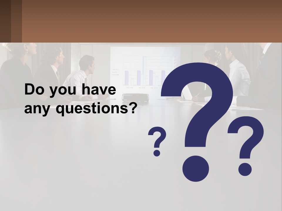 A Group Of People Sitting Around A Conference Table PowerPoint Template