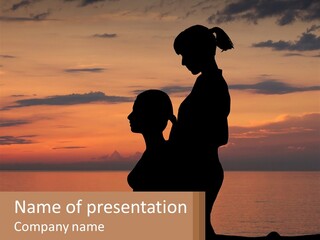 A Silhouette Of A Woman And Child Against A Sunset PowerPoint Template