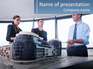 A Group Of People Standing Around A Model Of A Building PowerPoint Template