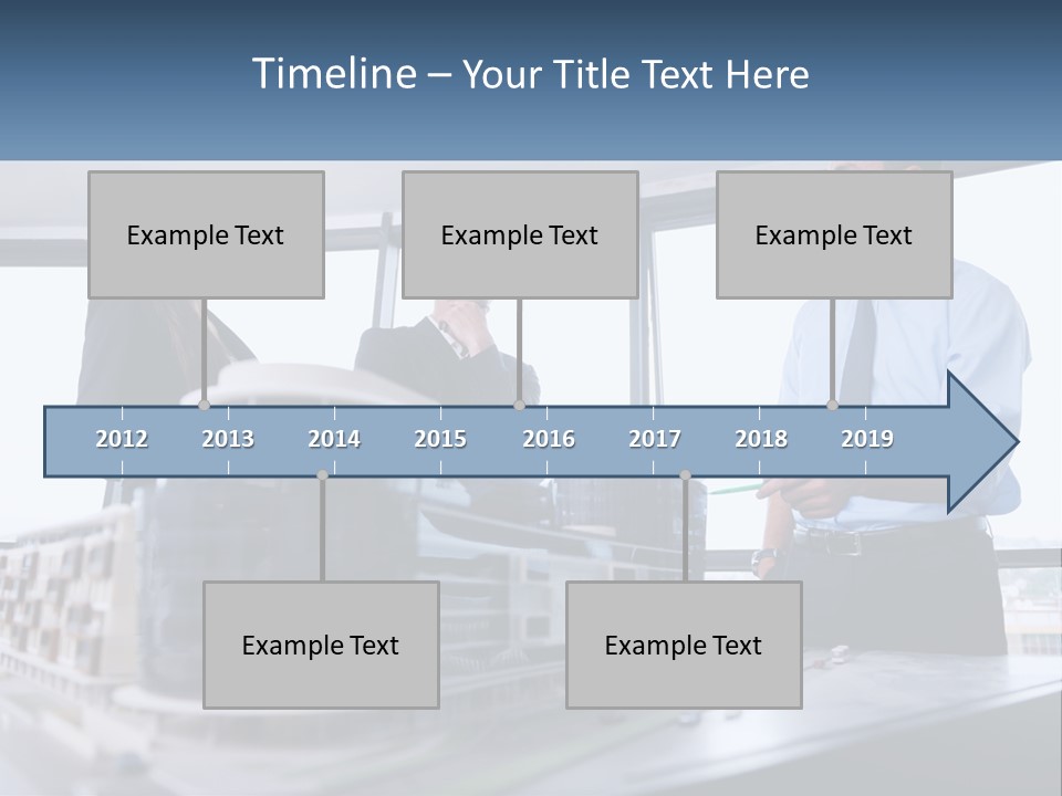 A Group Of People Standing Around A Model Of A Building PowerPoint Template