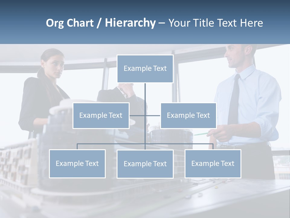 A Group Of People Standing Around A Model Of A Building PowerPoint Template