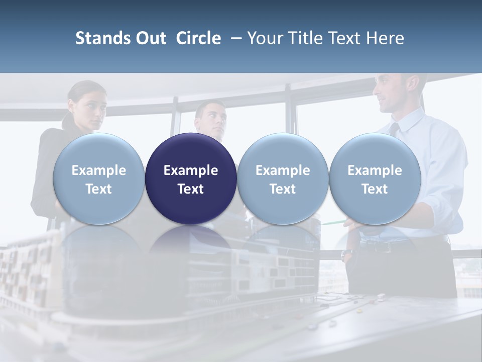 A Group Of People Standing Around A Model Of A Building PowerPoint Template