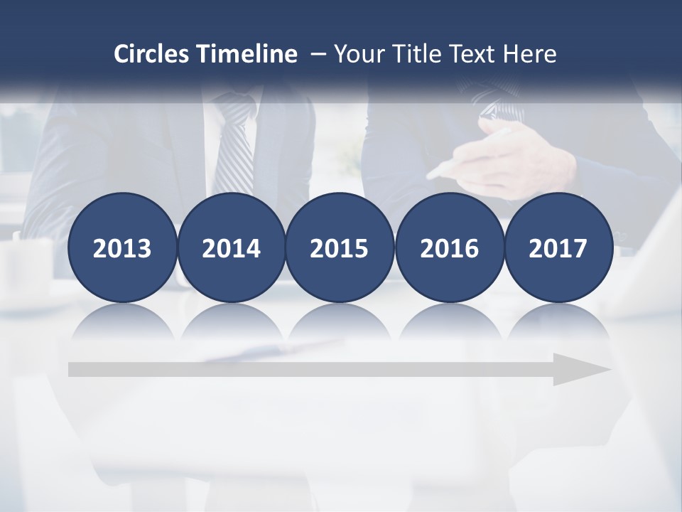 Two Men Sitting At A Table Looking At A Tablet PowerPoint Template