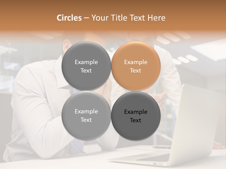 Two Men Sitting At A Table Looking At A Laptop PowerPoint Template