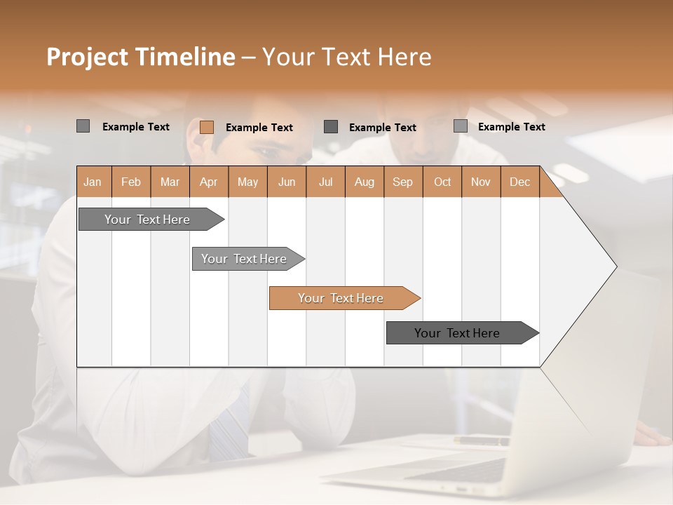Two Men Sitting At A Table Looking At A Laptop PowerPoint Template