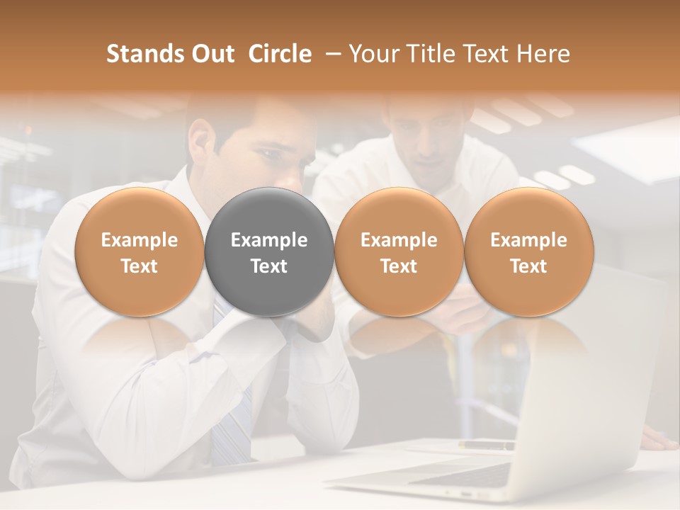 Two Men Sitting At A Table Looking At A Laptop PowerPoint Template