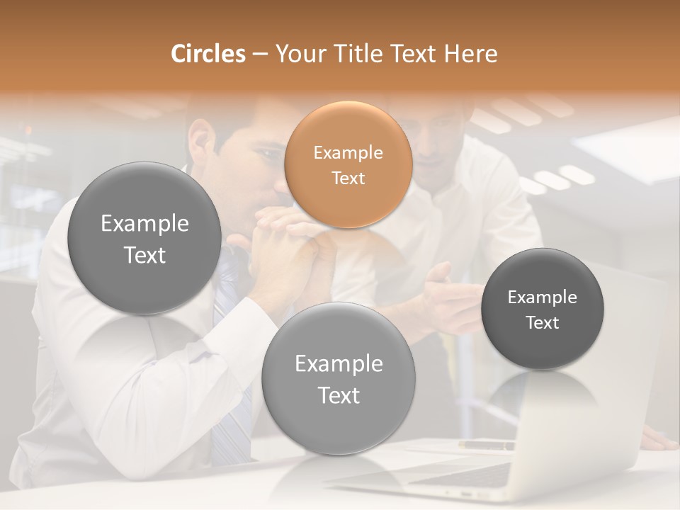 Two Men Sitting At A Table Looking At A Laptop PowerPoint Template