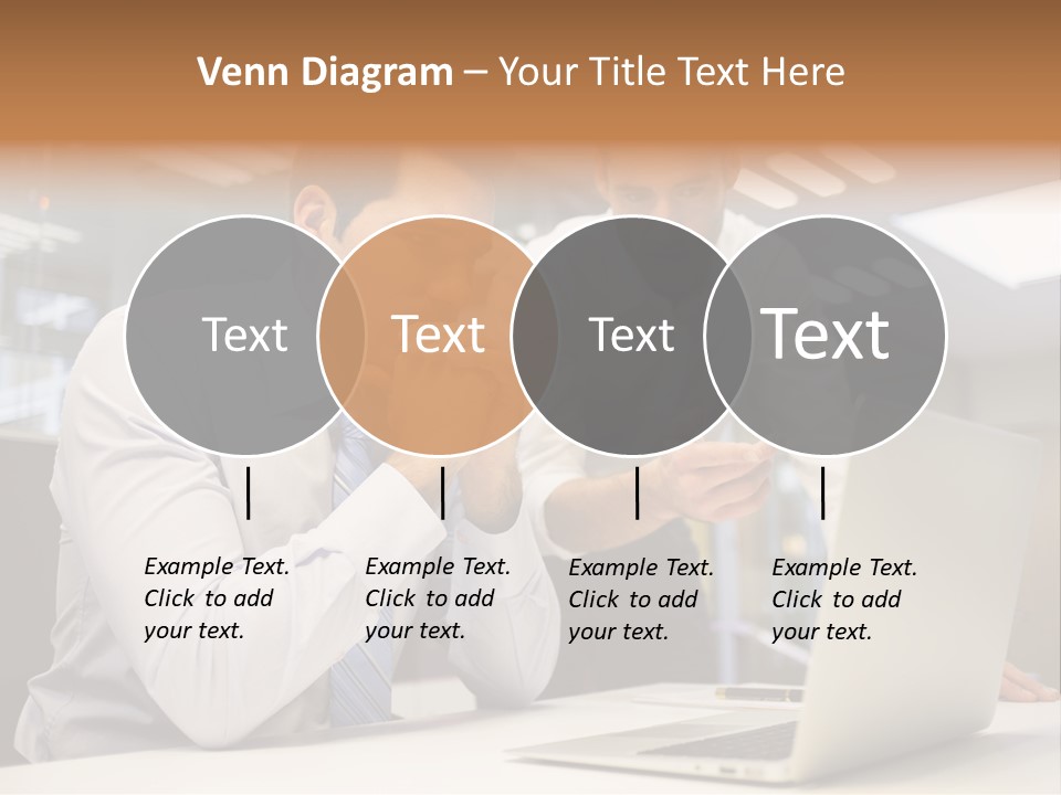 Two Men Sitting At A Table Looking At A Laptop PowerPoint Template