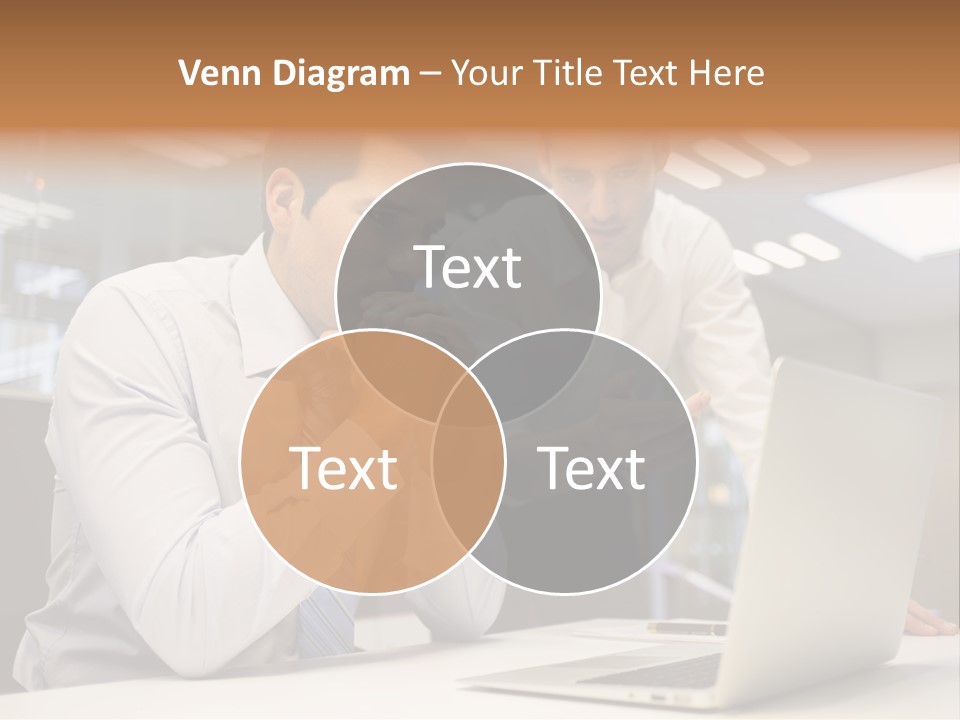 Two Men Sitting At A Table Looking At A Laptop PowerPoint Template