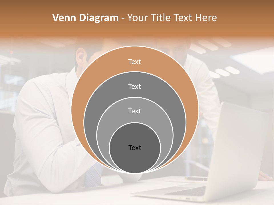 Two Men Sitting At A Table Looking At A Laptop PowerPoint Template
