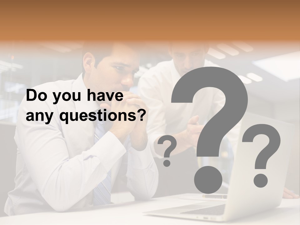 Two Men Sitting At A Table Looking At A Laptop PowerPoint Template