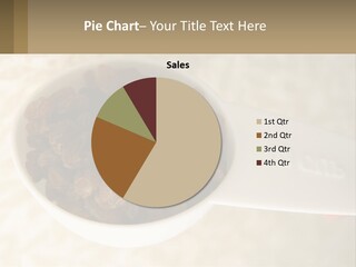 A White Spoon Filled With Raisins On Top Of A Table PowerPoint Template