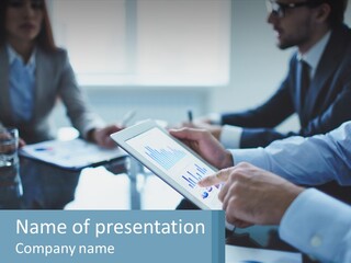A Group Of People Sitting Around A Table With A Tablet PowerPoint Template