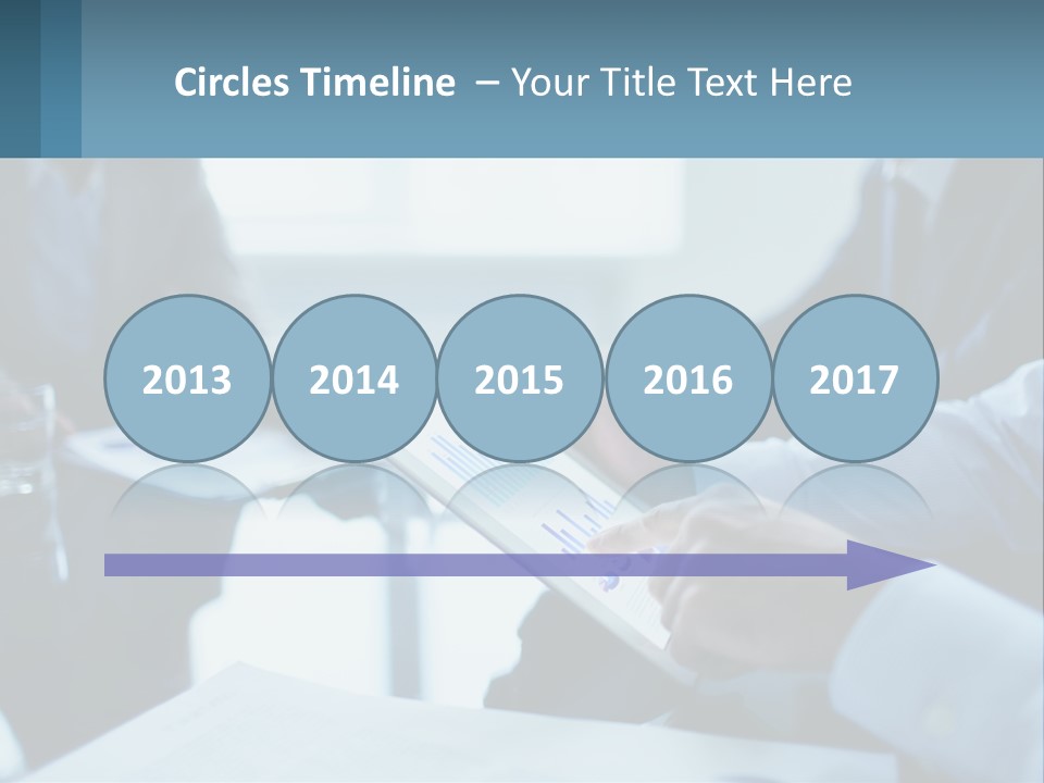 A Group Of People Sitting Around A Table With A Tablet PowerPoint Template